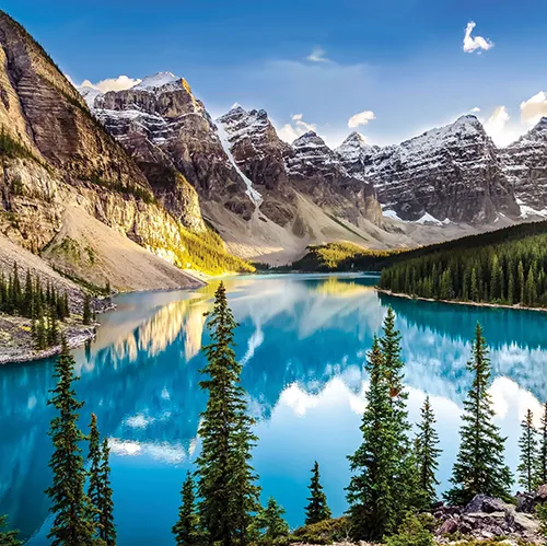 Beautiful snow-capped mountains and a clear lake with blue skies
